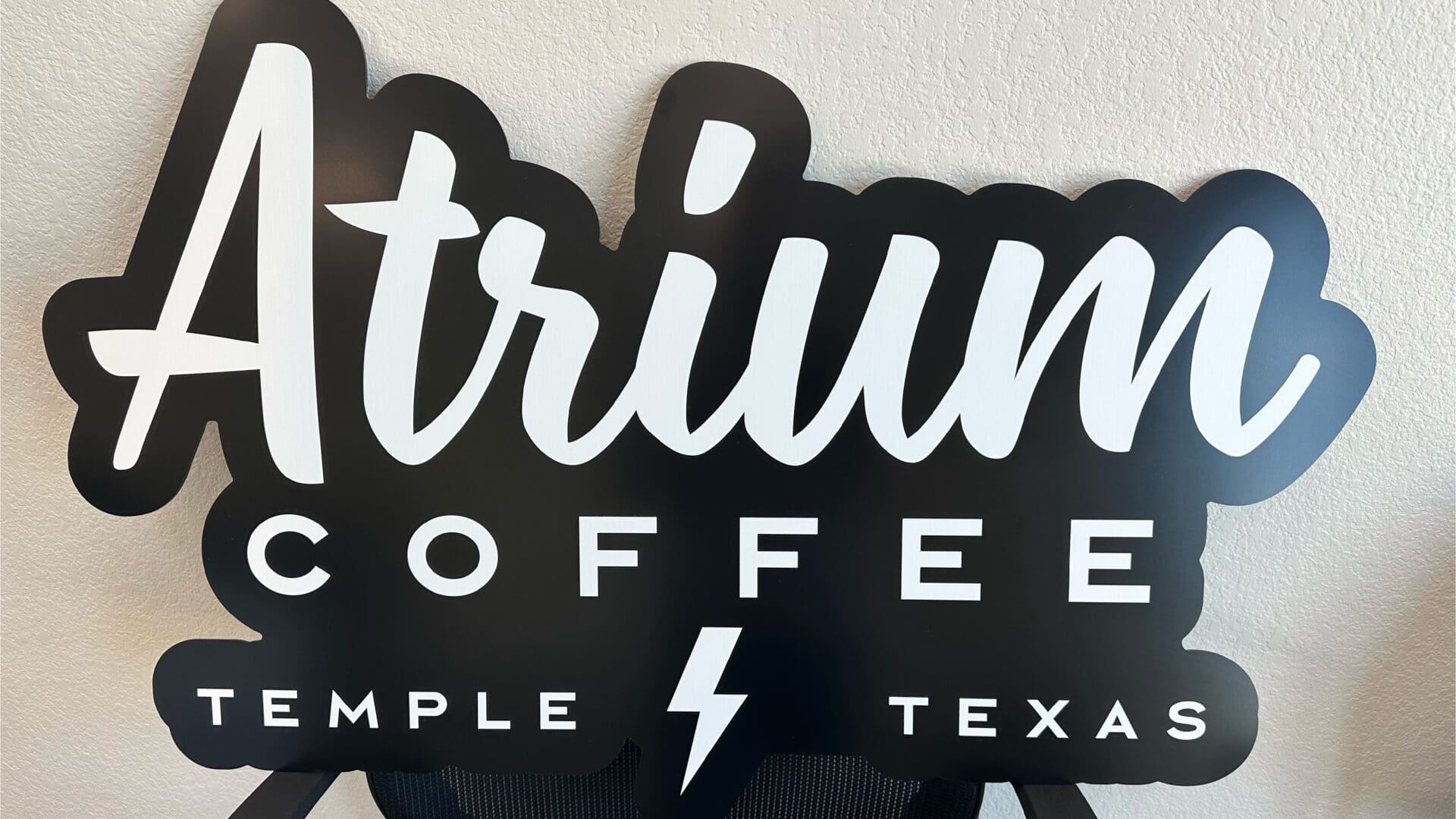 Atrium Coffee sign displaying Temple Texas and bolt