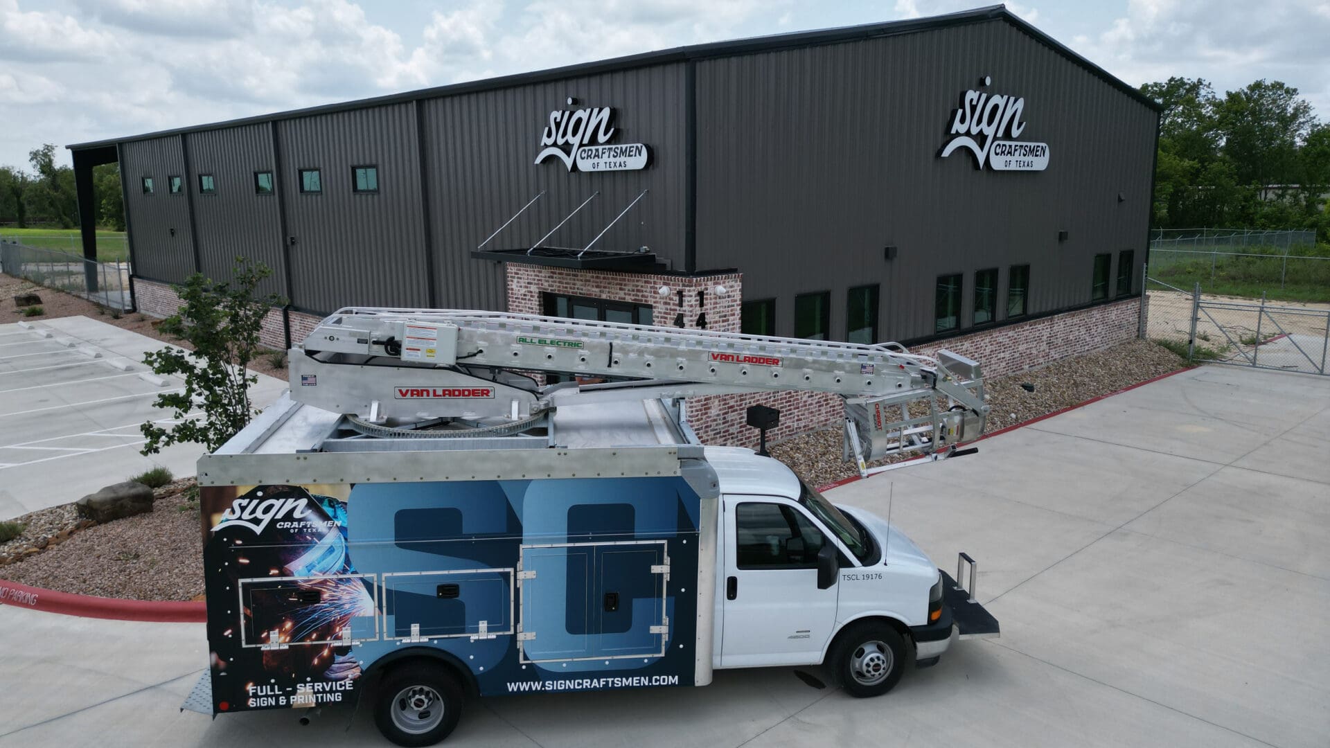 Sign Craftsmen van with ladder parked outside