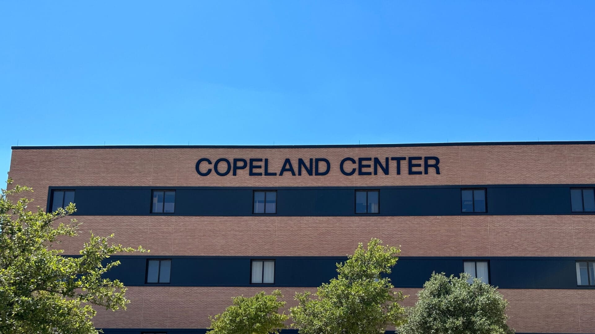 Copeland Center sign above windows and trees