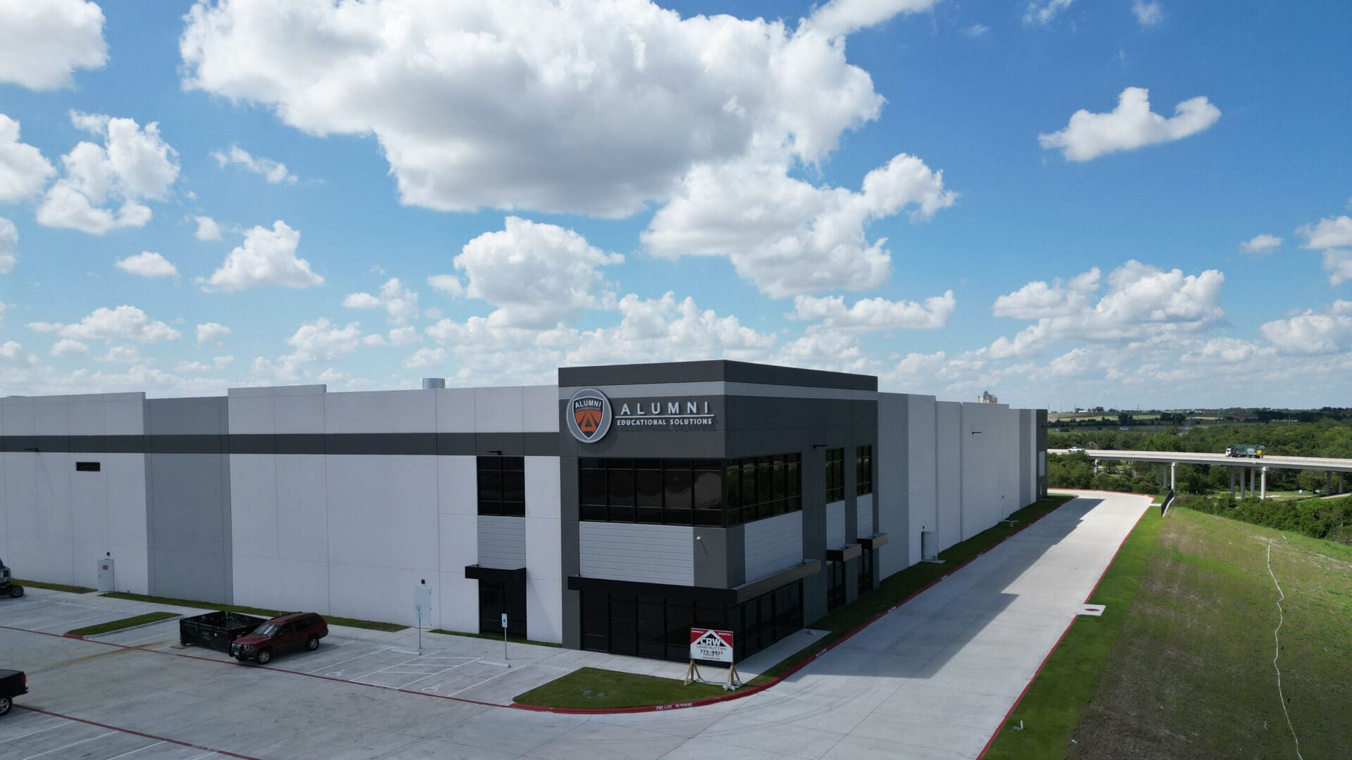 Alumni Educational Solutions warehouse under blue sky