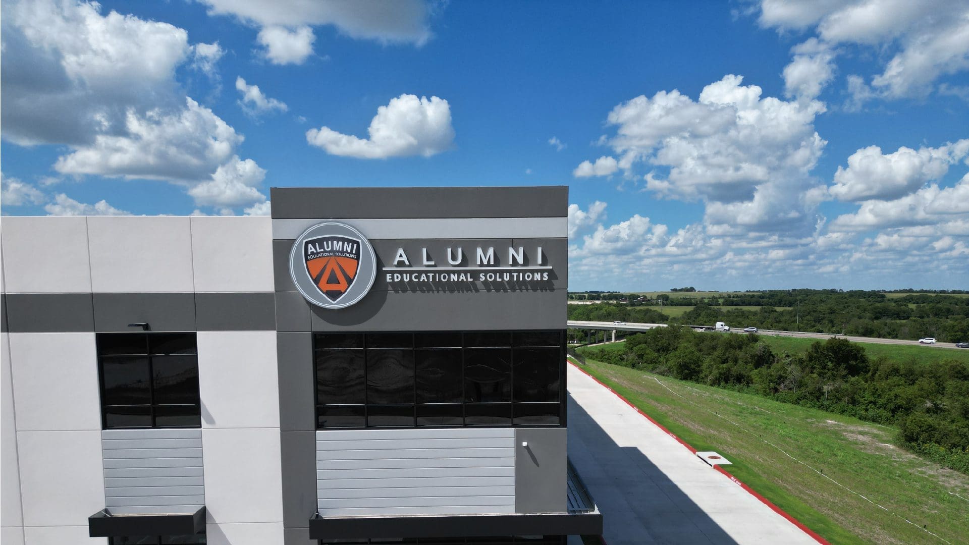 Alumni Educational Solutions building sign and sky