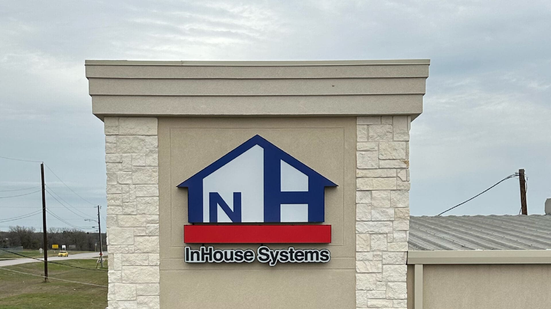 Blue and red InHouse Systems building emblem