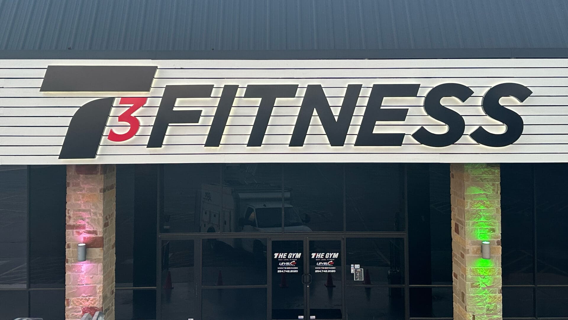 T3 Fitness storefront sign with backlit letters