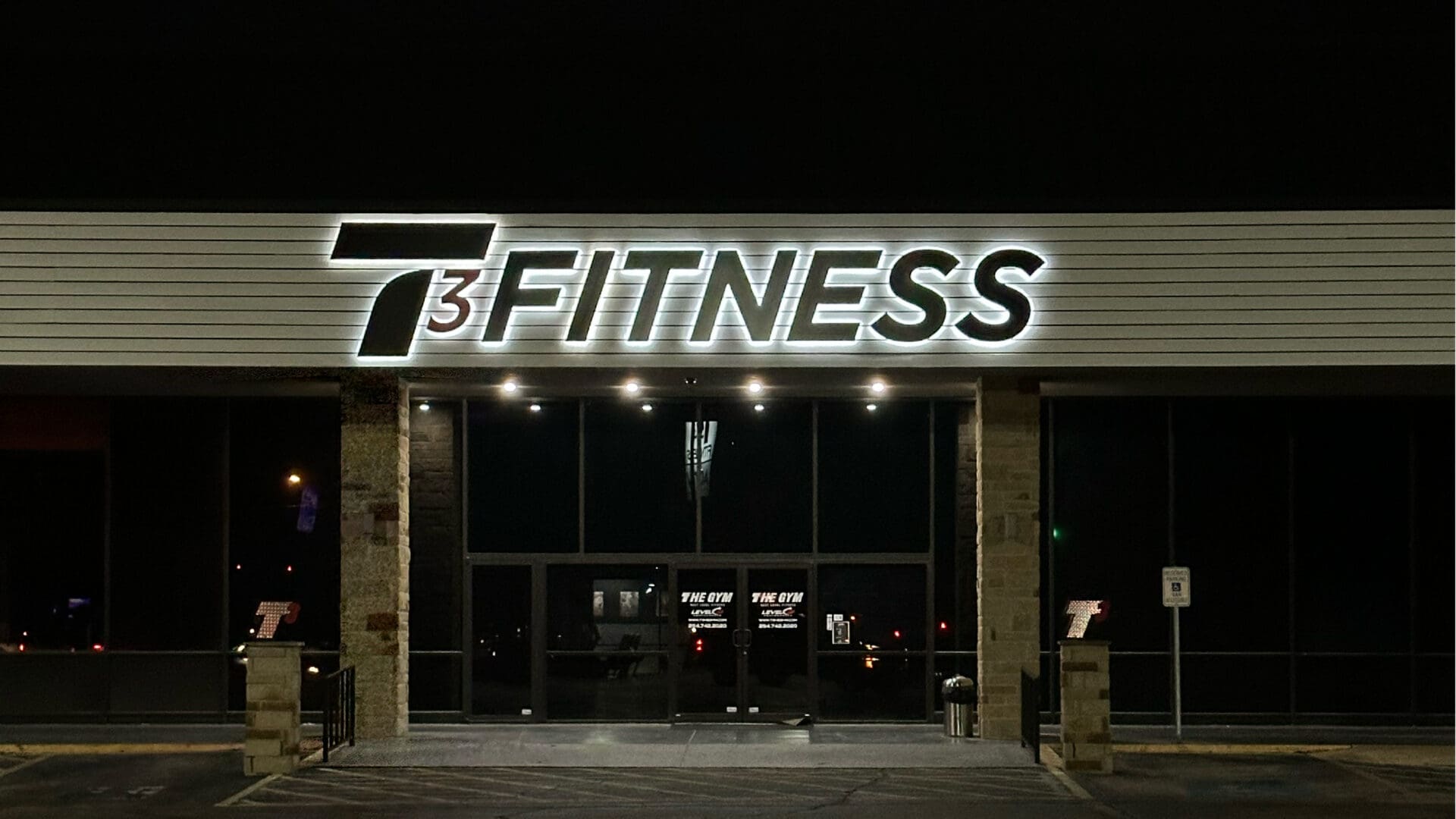7 Cubed FITNESS storefront sign at night